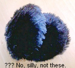 Black furry ear muffs with caption - No, silly, not these. 