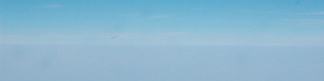A hazy horizon, barely distinguishable from the sky above