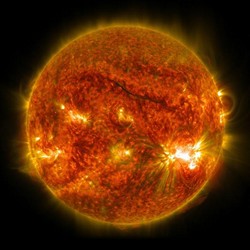 The sun, with hot spots and solar flares bubling up from the surface