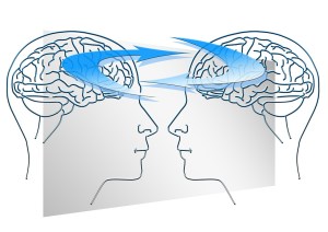 A sketch of two transparent human heads facing each other, with the brains connected by curved arrows
