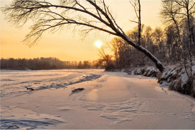 A sunset over a frozen lake