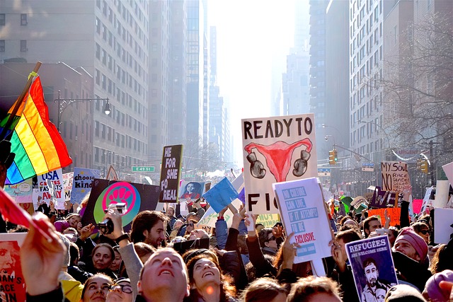 View of the January 21, 2017 women's march in a major city with protestors filling the street between tall buildings and holding signs