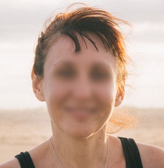 Smiling face of a woman with features blurred