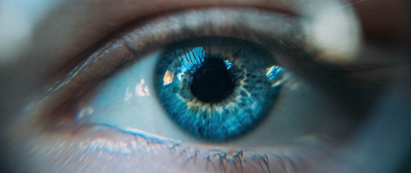 Close up view of an aqua colored eye on a young, pale-skinned person