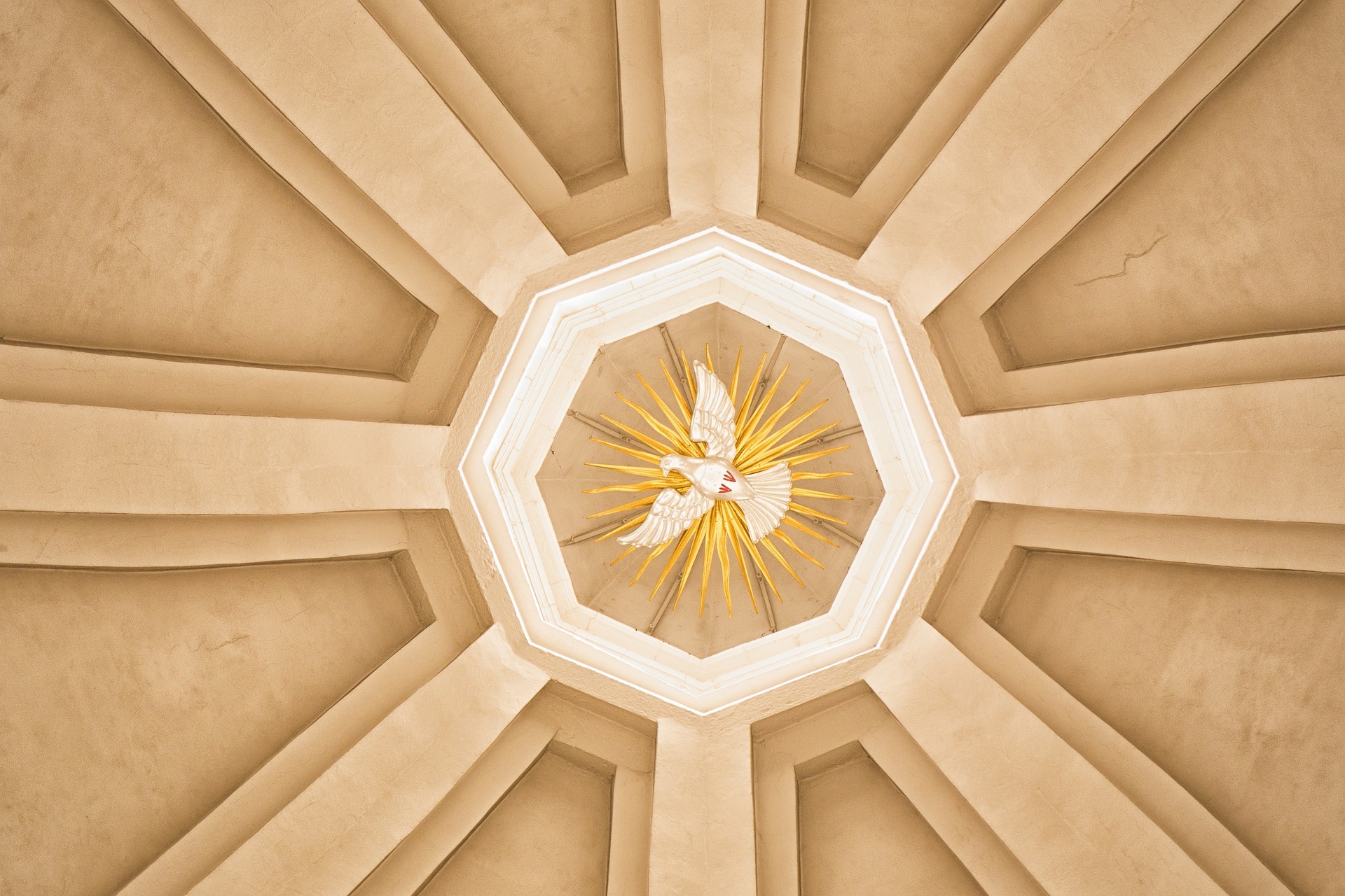 Image by Rainer Maiores (Pixabay) A white peace dove painted in the circular center of a vaulted roof