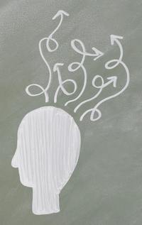 A chalk drawing on a greenboard of a silhouetted head with many curving and looping arrows coming out of it in all directions